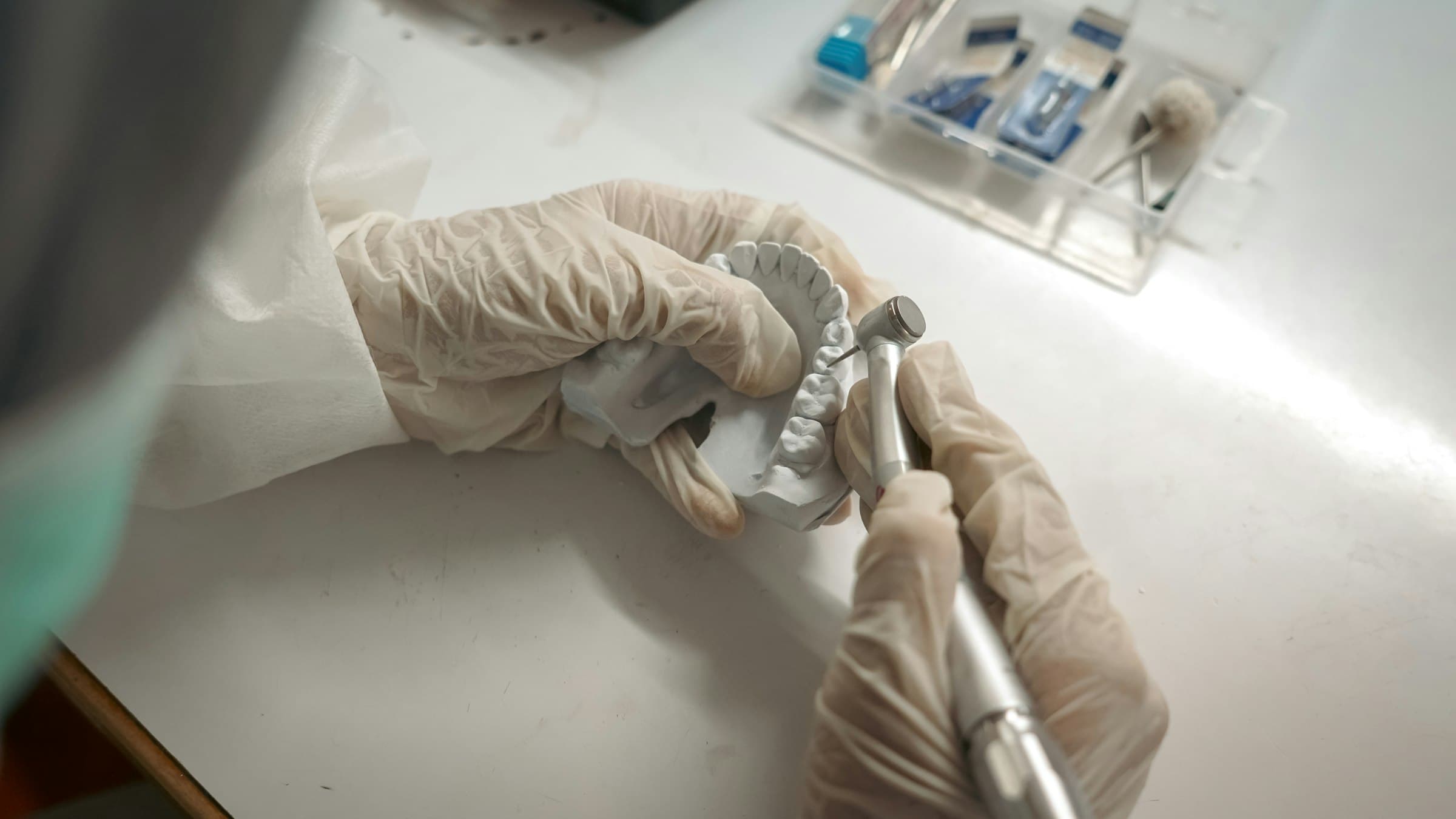 Hands shaping a dental model by hand
